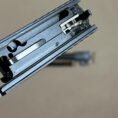 Sig Sauer P320 9mm slide assembly with barrel, showcasing detailed firearm mechanics and design.