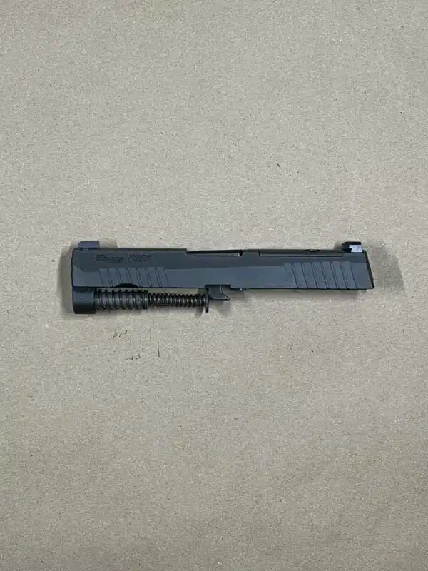 Sig Sauer P320 9mm slide assembly with night sights, optic-ready for compact firearms.