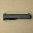Sig Sauer P365 9mm slide assembly with barrel and night sights viewed on a neutral surface.