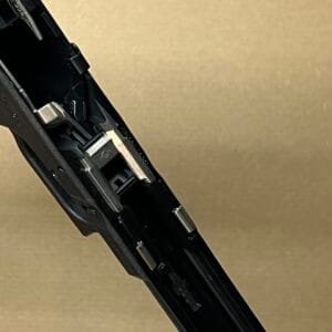 Glock 17 Gen 3 factory lower frame parts showcasing intricate firearm mechanics and design.