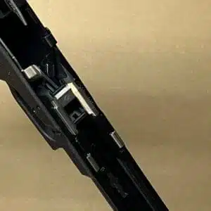 Glock 17 Gen 3 factory lower frame parts showcasing intricate firearm mechanics and design.