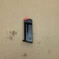 Smith & Wesson MP9 Shield Plus OEM 10-round magazine with red indicator and matte finish.