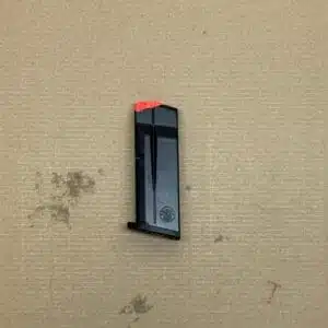 Smith & Wesson MP9 Shield Plus OEM 10-round magazine with red indicator and matte finish.