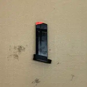 Black 13-round Smith & Wesson MP9 Shield Plus OEM magazine with an orange tip for safety.