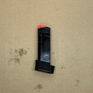 15 Round Smith & Wesson M&P9 Shield Plus magazine with red tip on textured surface.