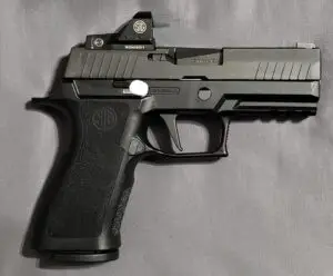 Sleek black semi-automatic handgun TCM stock with ergonomic grip and red dot sight.