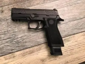 Sleek black semi-automatic pistol with modern design and textured grip for enhanced performance.