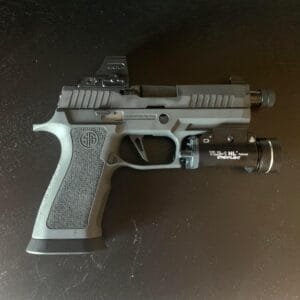 Modern handgun with tactical light and reflex sight for enhanced performance and precision.