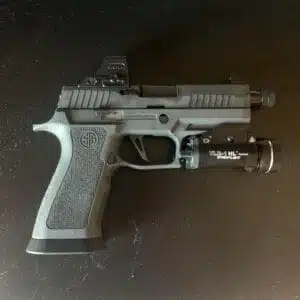 Modern handgun with tactical light and reflex sight for enhanced performance and precision.