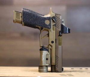 Stylish tactical gold handgun featuring custom design and integrated flashlight for enhanced performance.