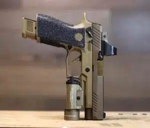 Stylish tactical gold handgun featuring custom design and integrated flashlight for enhanced performance.