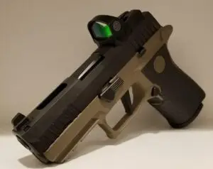 Tactical handgun with reflex sight and olive-green stock for enhanced accuracy and control.
