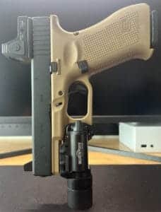 Tan semi-automatic pistol with tactical flashlight, ideal for defense and tactical use.