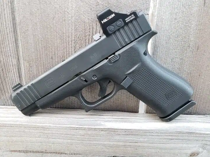 Sleek Glock 48 pistol with red dot sight, perfect for everyday carry and precision shooting.