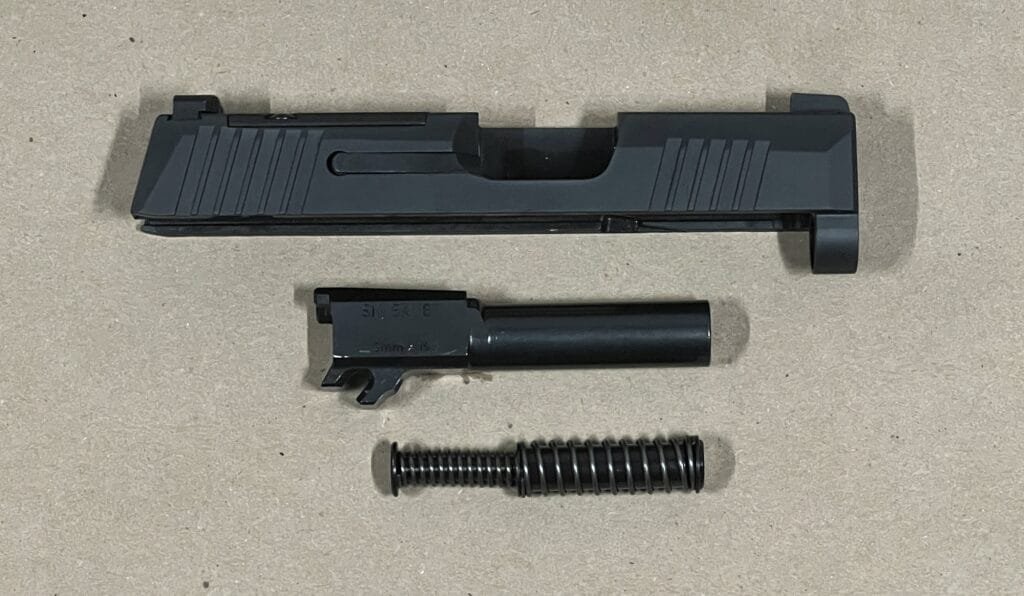 Sig Sauer P365 firearm components: slide, barrel, and recoil spring for everyday carry.