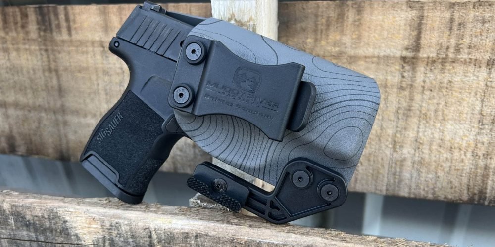 The Sig Sauer P365: The Compact Powerhouse for Everyday Carry Sig Sauer P365 in a tactical holster, ideal for everyday concealed carry.